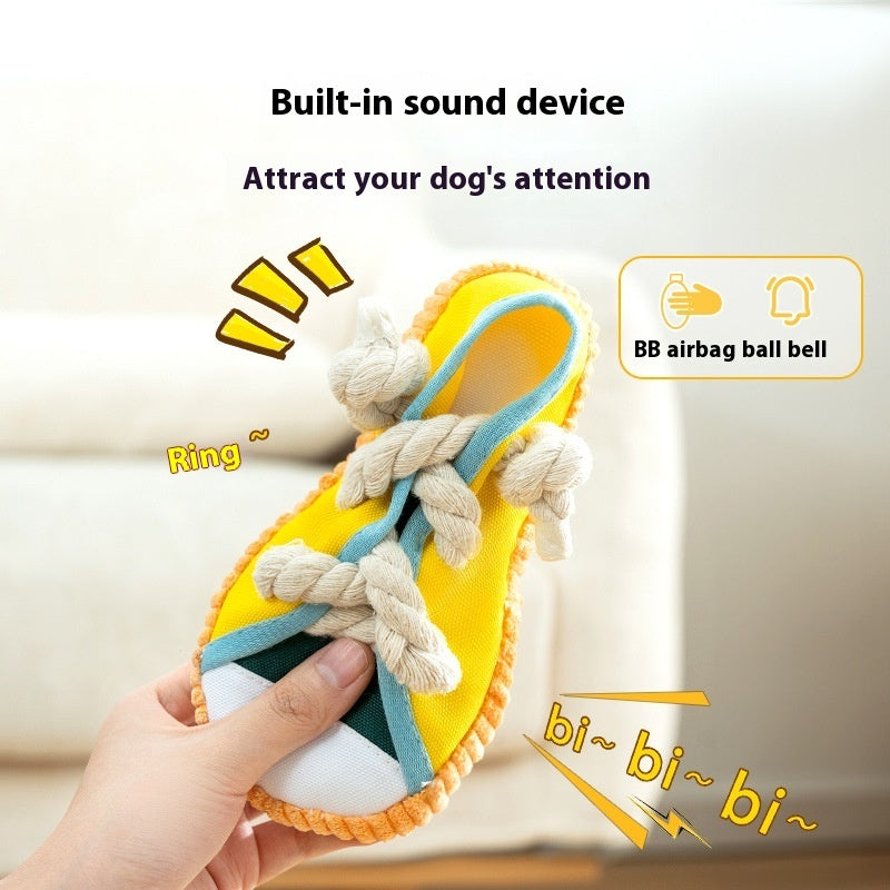 Squeaky plush shoe dog toy in yellow with blue trim and white braided rope laces