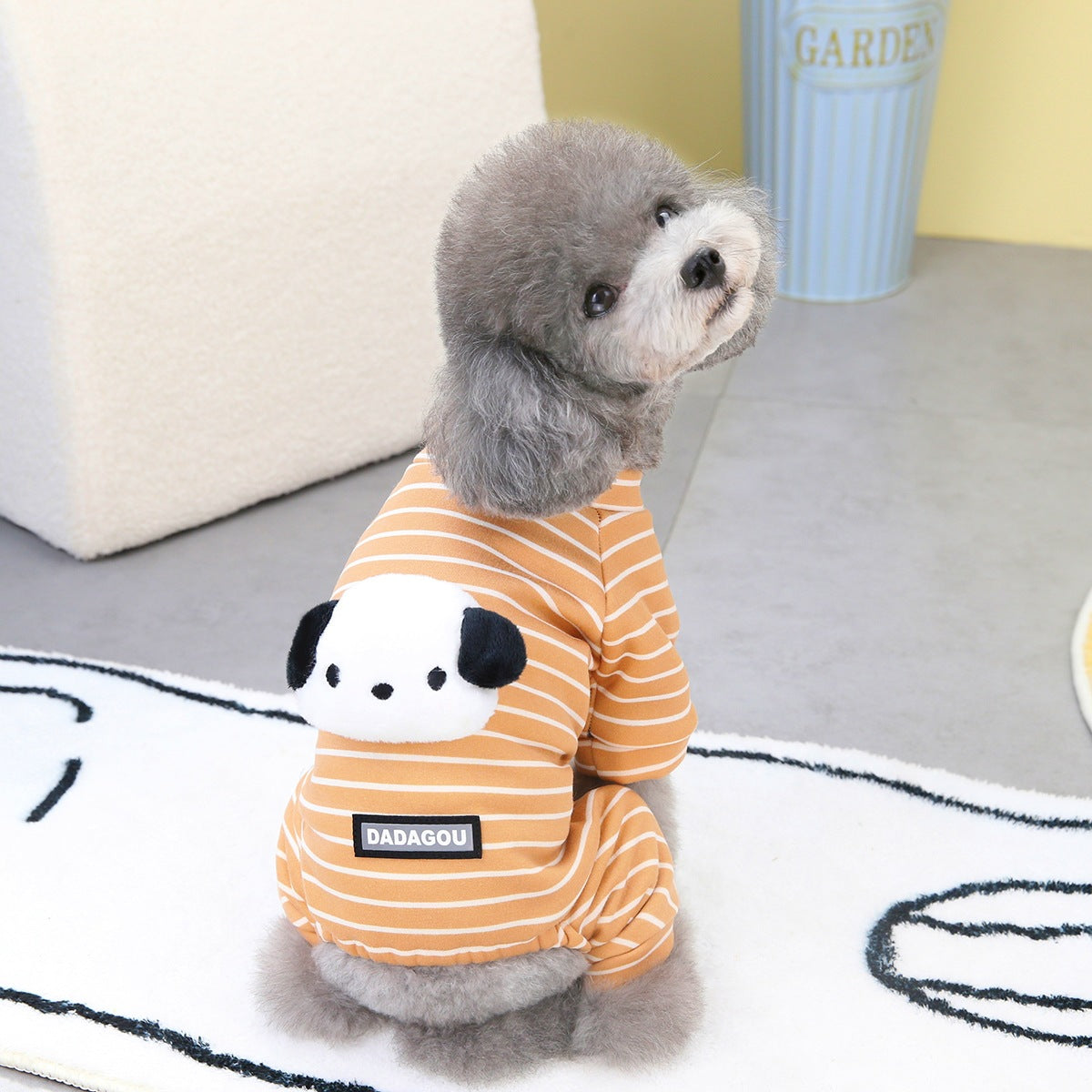 Orange striped two-leg dog sweater with panda face patch on a small fluffy dog