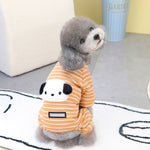 Orange striped two-leg dog sweater with panda face patch on a small fluffy dog