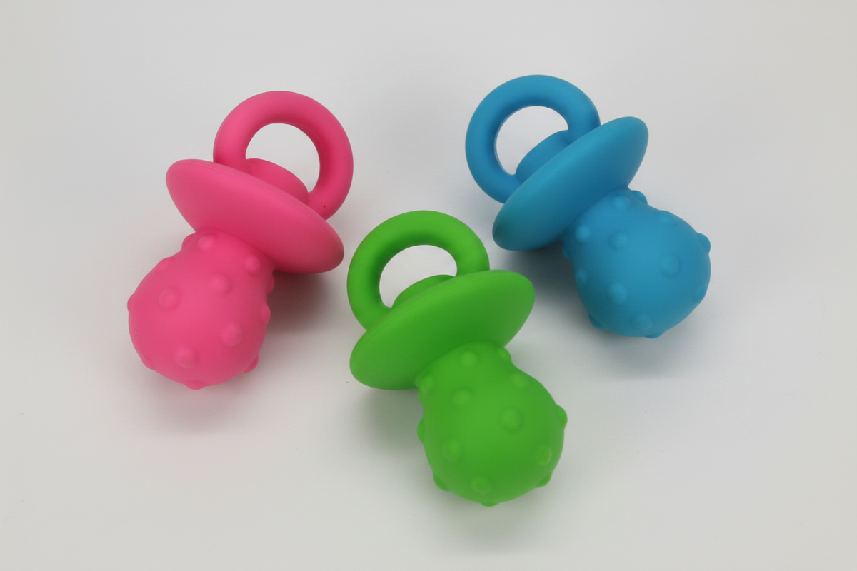Latex squeaky pacifier dog toy set in pink, green, and blue with textured bulb