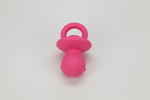 Latex squeaky pacifier dog toy in pink, with ring handle and textured bulb