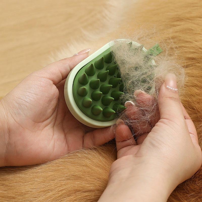 Silicone pet hair remover comb with green bristle head, held by hands during grooming