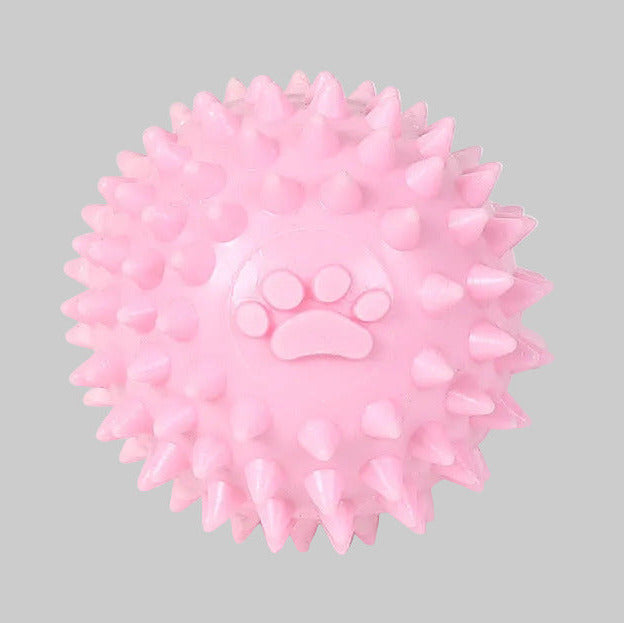 Spiky dog throwing ball toy with raised paw print, pink