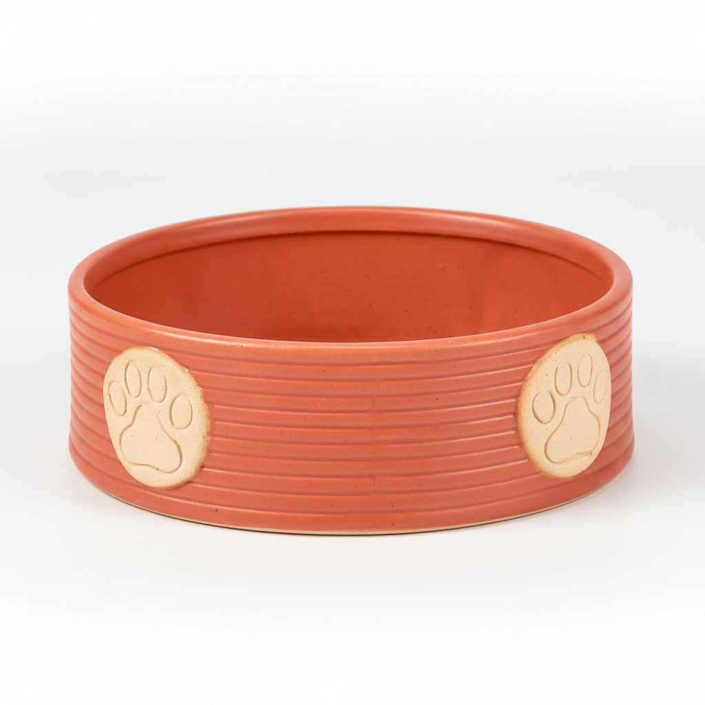 Orange large pet bowl with two beige paw print markers on the rim