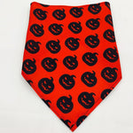 Red pet triangle bandana with black jack-o’-lantern face pattern throughout
