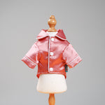 Pink satin pet pajama jacket on mannequin with white-trimmed zipper and hood collar