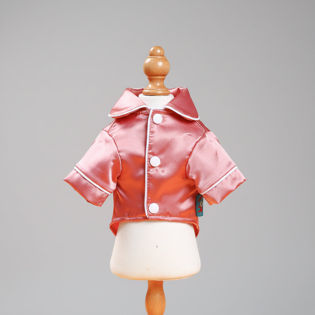 Pink satin pet pajama jacket on mannequin with white-trimmed zipper and hood collar
