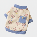 Cream fleece pet sweatshirt with blue ribbed trim and paw-print chest pocket
