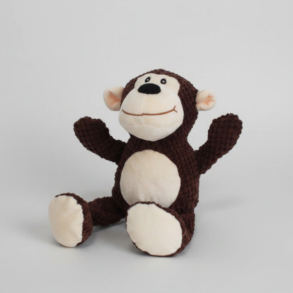 Brown and white monkey plush pet toy with curled tail and round stitched face