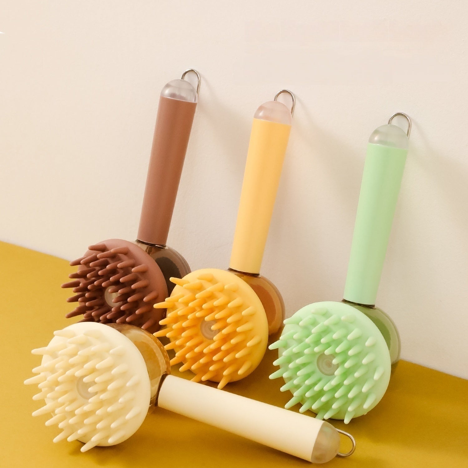 3-in-1 pet bath brush set with round heads in brown, yellow, and green