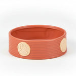 Orange large pet bowl with ribbed sides and beige paw print accents