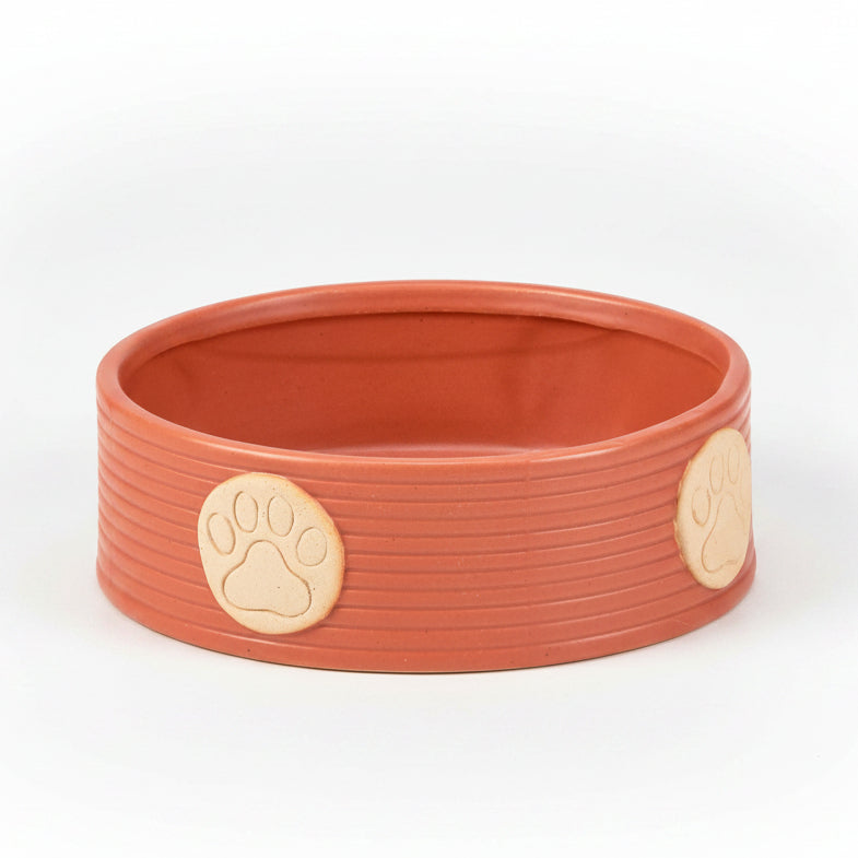 Orange large pet bowl with ribbed sides and beige paw print accents