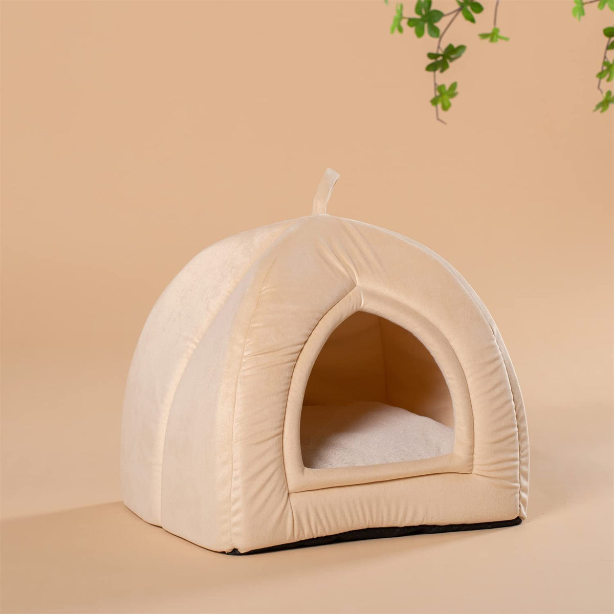Beige plush pet tent bed with arched front opening and hanging loop