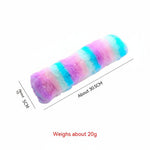 Long plush cat pillow toy in purple, pink, turquoise, and blue rainbow stripes