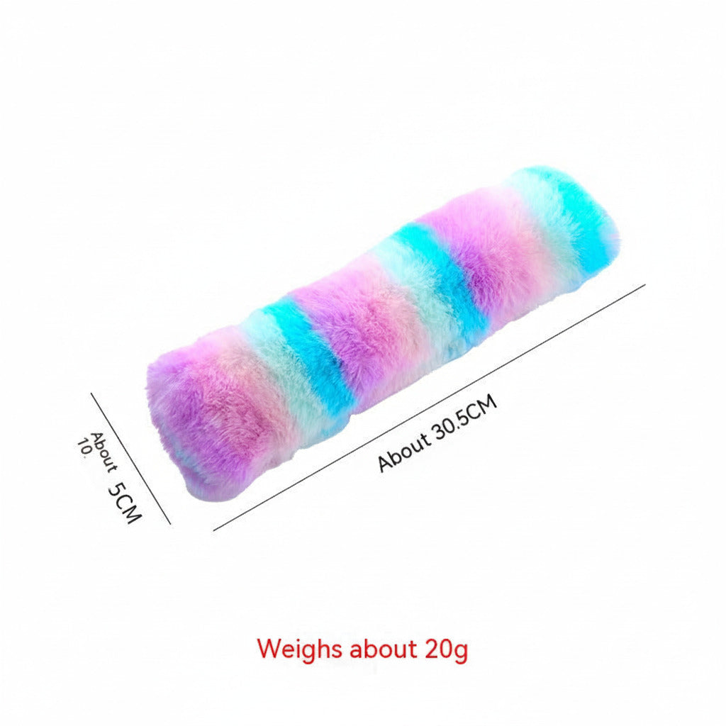 Long plush cat pillow toy in purple, pink, turquoise, and blue rainbow stripes
