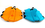 Orange and blue dog swim suits laid side by side with black strap closures