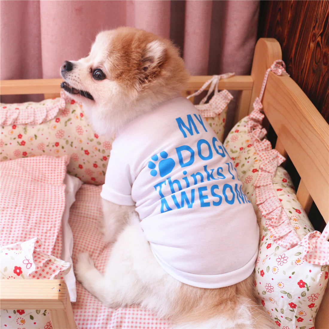 White cotton dog summer vest on small dog, with blue paw logo and “Think I’m Awesome”