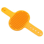 Yellow silicone pet grooming brush with raised massage spikes and wrist holes