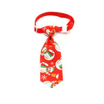 Red Christmas pet tie with penguin and snowflake patterns, clip-on strap