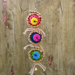Hanging bird rope toy with three braided balls, colorful gear wheels, and a small bell
