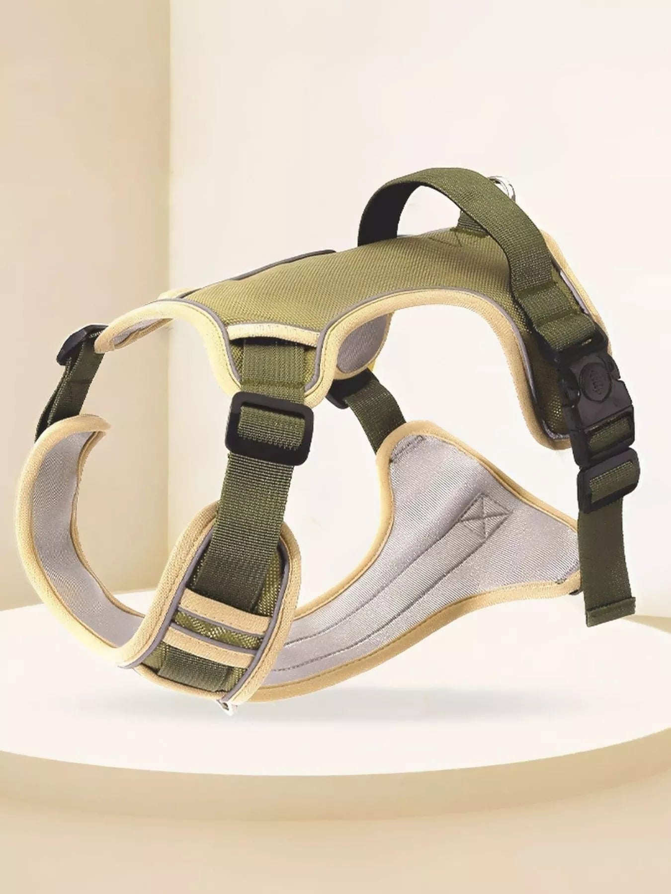 Adjustable pet harness with olive green straps and padded inner panel, side close-up