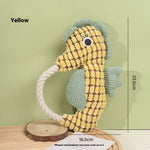 Yellow seahorse plush dog toy with rope handle and textured scale pattern