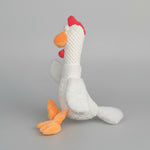 White plush animal toy with red cap and orange beak and feet, textured knit fabric