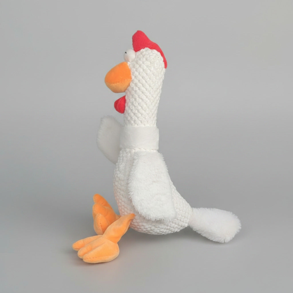 White plush animal toy with red cap and orange beak and feet, textured knit fabric