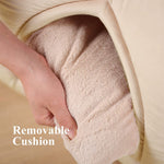 Removable beige cushion insert for pet tent bed, held in hand