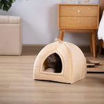 Beige soft arched cat bed cushion with open doorway; cat resting inside