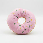 Pink plush donut dog toy with rainbow sprinkles and round center hole