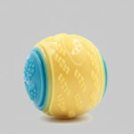 Dog training ball toy with yellow and blue textured halves