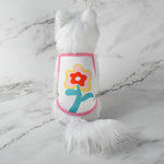 Cute pet tank top with white fur and pink trim, yellow flower-themed cartoon graphic on front.