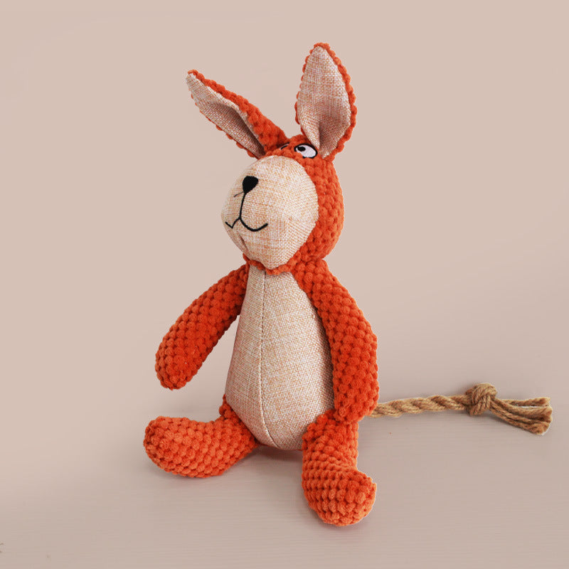 Orange bunny plush pet toy with beige face and long ears, with rope tail