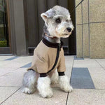 Khaki pet winter jacket hoodie with zip front and dark ribbed cuffs, on a sitting dog.
