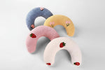 Plush U-shaped cat pillow toys set: blue, tan, pink, and white with small fruit patches