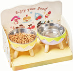 Two elevated stainless steel pet bowls with legs on a yellow feeder tray