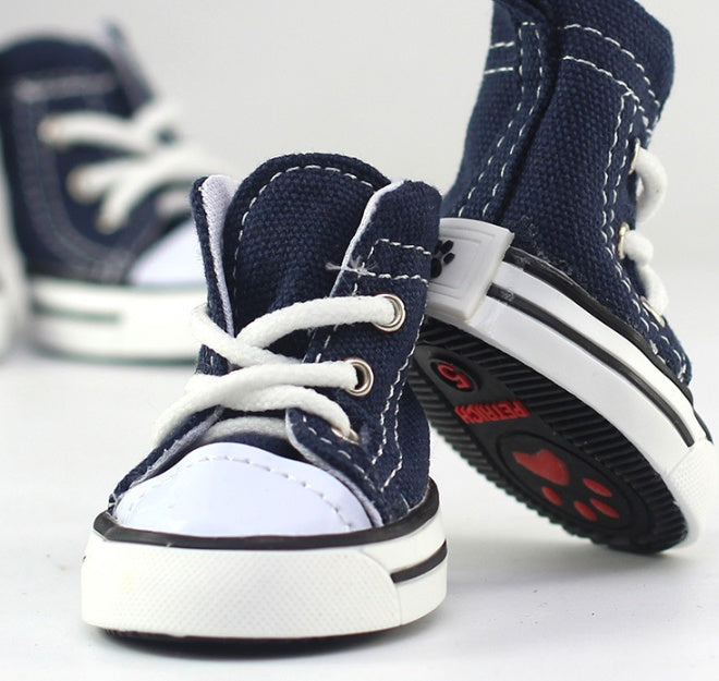 Pair of navy canvas dog sneakers with white laces and side stripe detail
