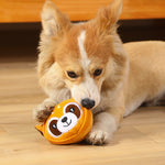 Pet dog playing with an orange tiger-faced bite-resistant teething plush toy