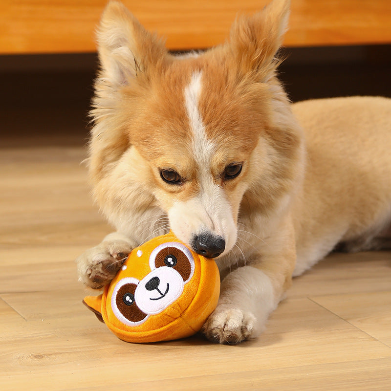 Pet dog playing with an orange tiger-faced bite-resistant teething plush toy