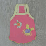 Pink cotton suspender pet vest with light yellow trim and embroidered flower appliques