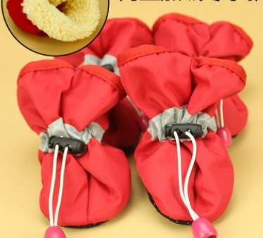 Red soft dog boots with lace-up cords and pink pull tabs