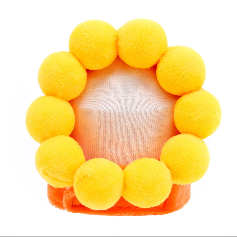 Sunflower-style plush pet hat with bright yellow petals and orange base