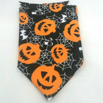 Pet triangle bandana scarf, black with orange jack-o’-lanterns, spiders, and web pattern