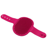 Pink silicone pet grooming brush with raised rubber massage bristles