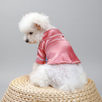 Pink satin pet pajama jacket from side view with white trim and short sleeves