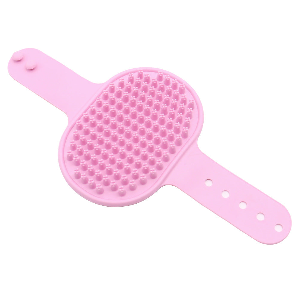 Light pink silicone pet grooming brush with massage nubs and wrist holes