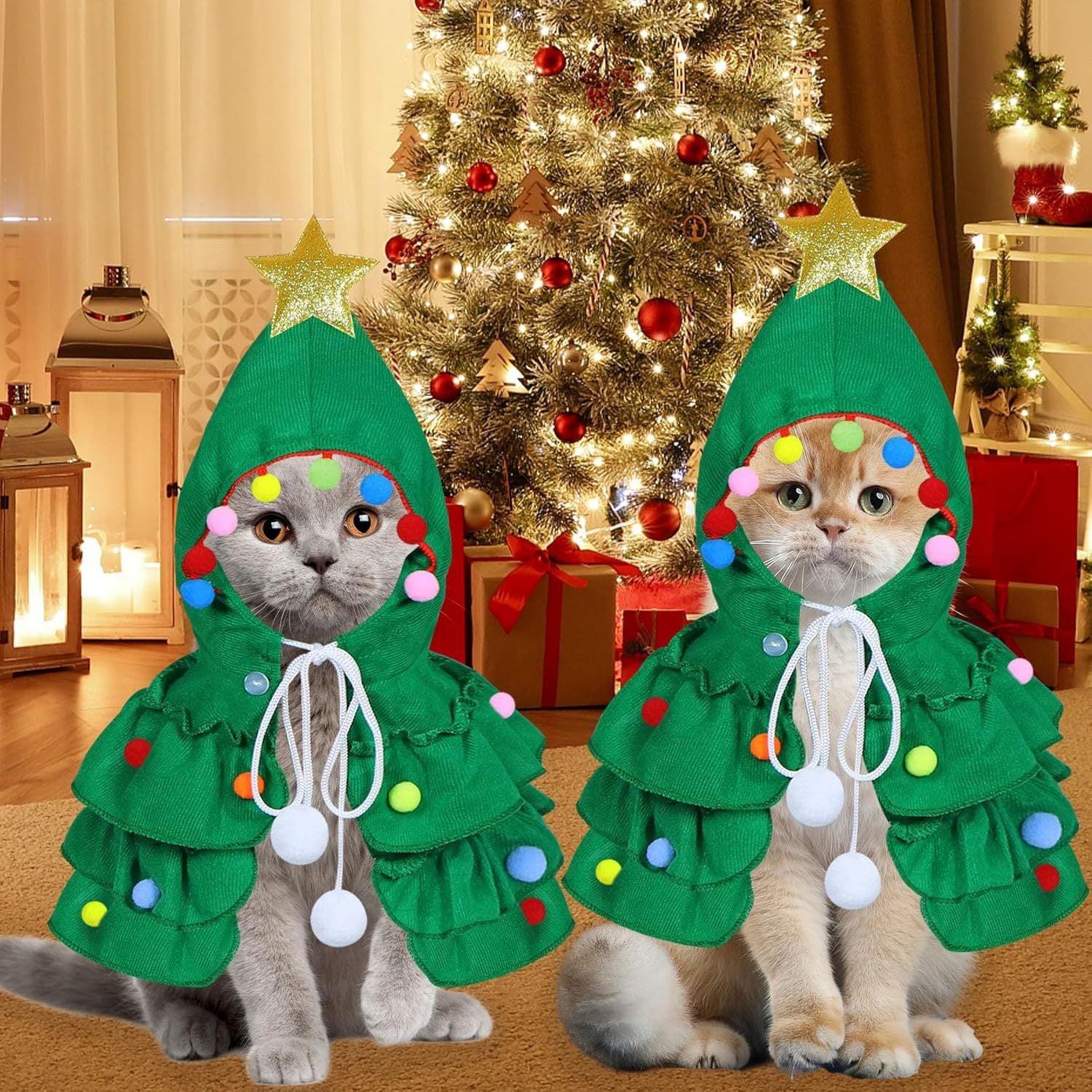 Two cats in green Christmas tree hooded costumes with gold star, colorful pom-poms, and white ties