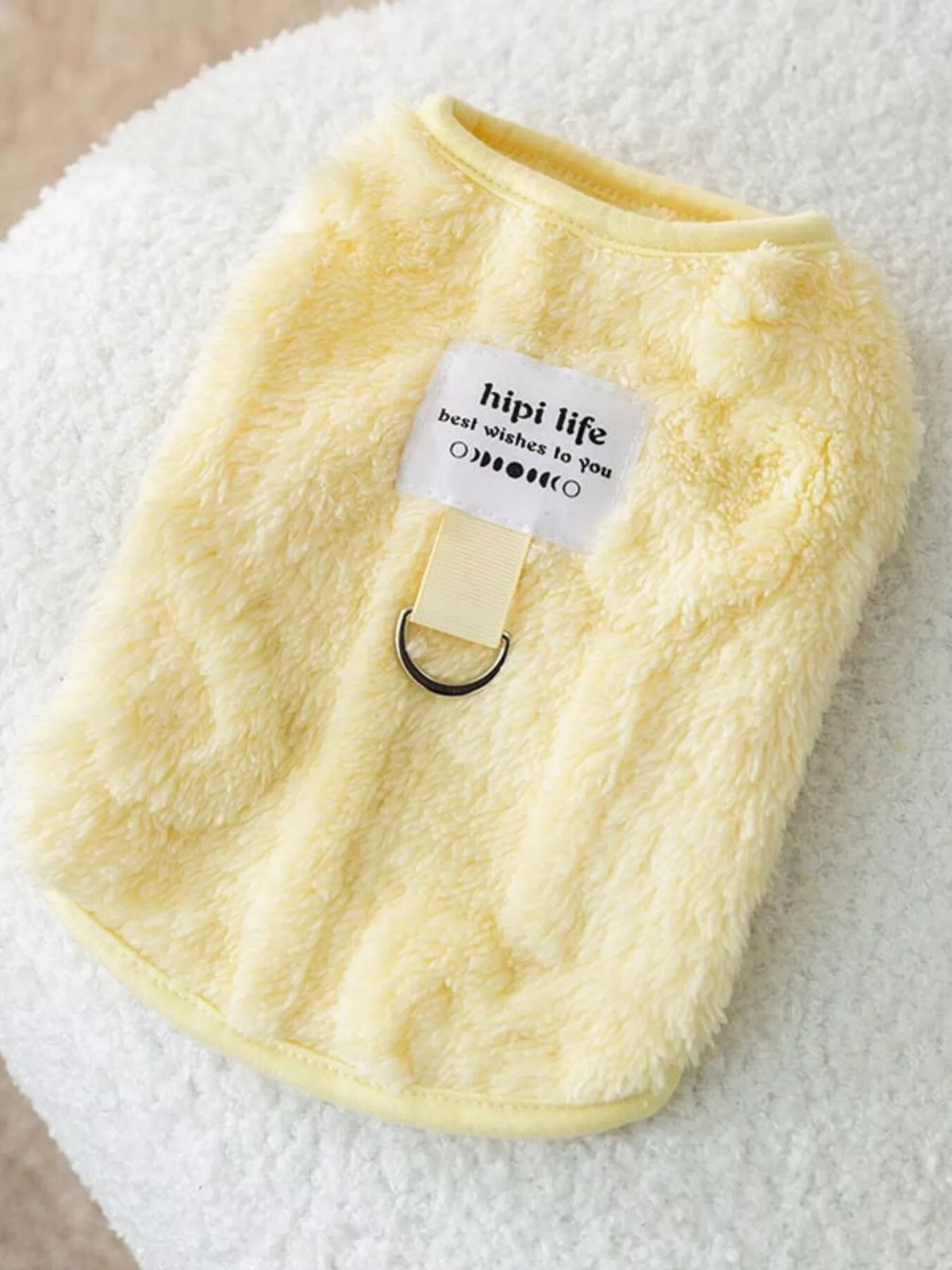 Yellow plush pet sweater with small tag and ribbed collar