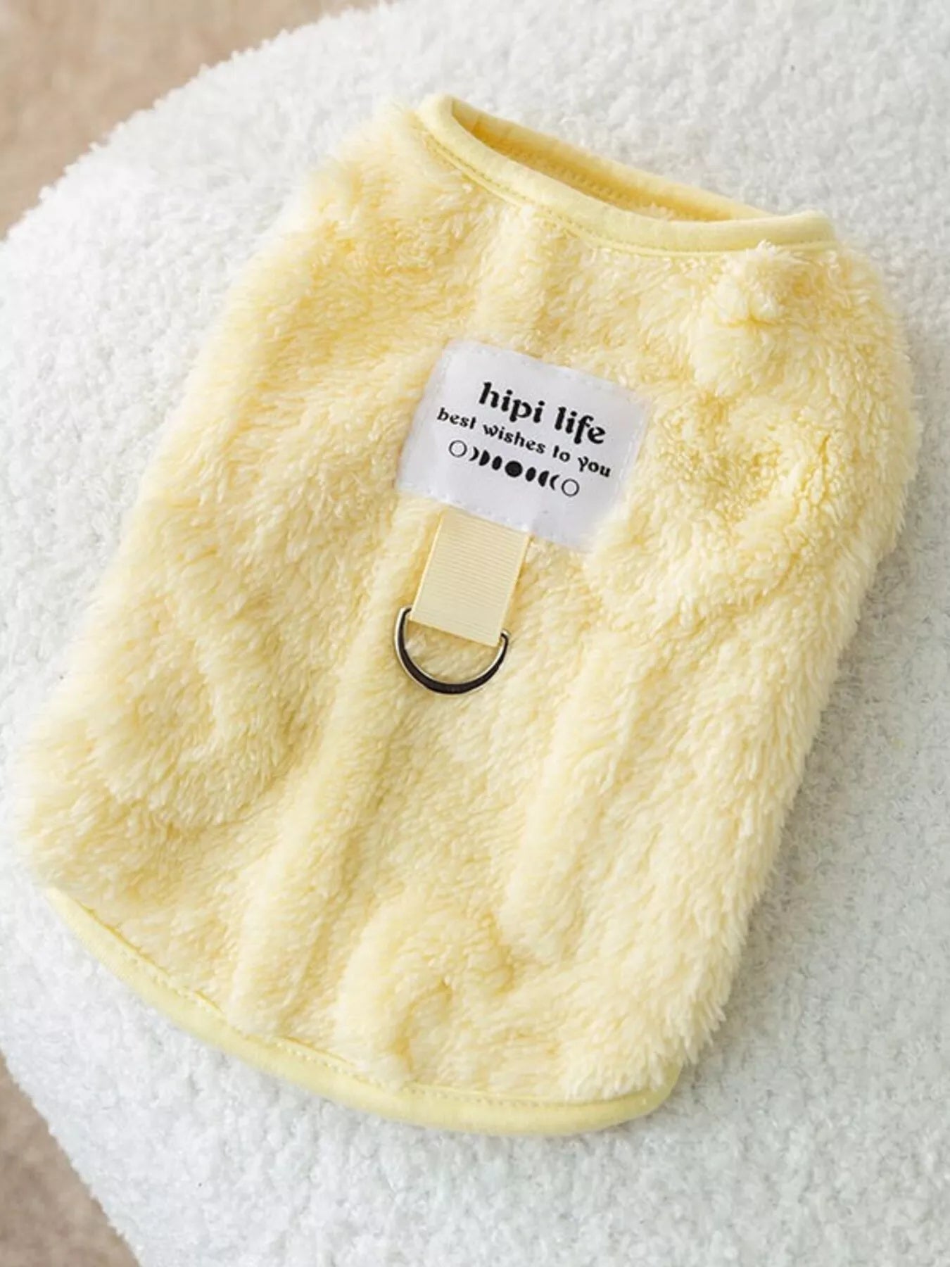 Yellow plush pet sweater with small tag and ribbed collar